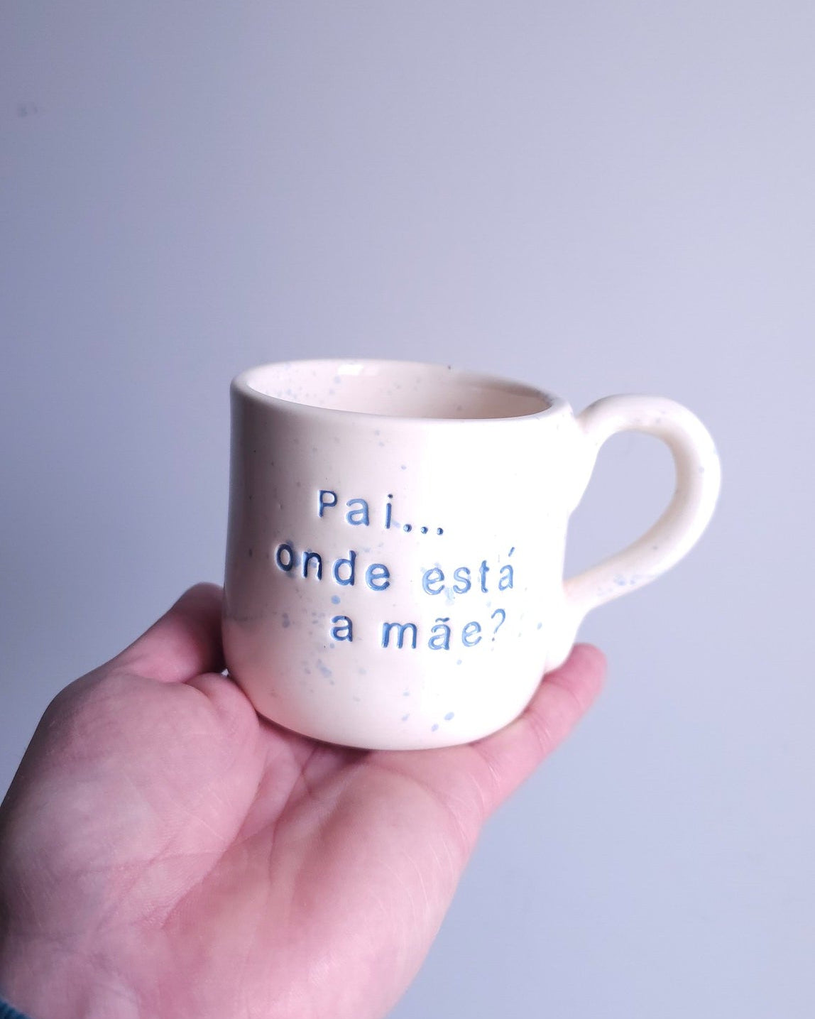 Caneca de cerâmica artesanal branca com asa e salpicado azul, modelo Francisca da Tia Cila, com a frase gravada "Pai... onde está a mãe?"